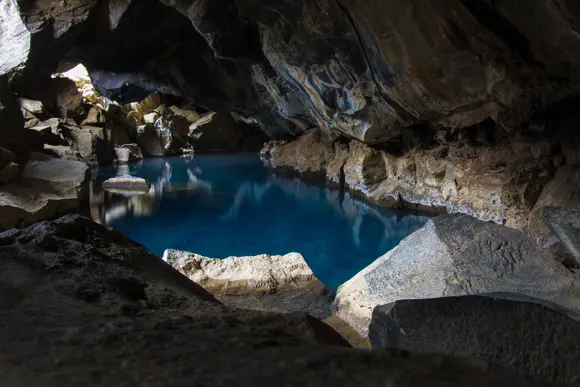 Steam rising from the thermal water in Grjótagjá cave